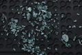 Broken glass with small pieces over black textured background. Royalty Free Stock Photo