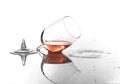 Broken glass with spilled red wine on white background Royalty Free Stock Photo