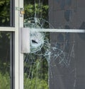 A broken glass window in an aluminum frame door Royalty Free Stock Photo