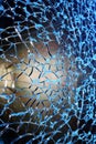 Broken glass window, color photo in blue tones. Royalty Free Stock Photo