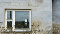 Broken glass window in the concrete wall of abandoned house. Texture and background Royalty Free Stock Photo