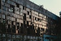 Broken glass windows wall in abandoned ruined factory building, destructed old plant facade Royalty Free Stock Photo