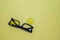 Broken glasses with folded arches lie on a yellow surface Royalty Free Stock Photo