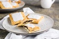 Broken glazed homemade pop tarts on a plate on the table. American pastry Royalty Free Stock Photo