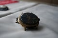 Broken gold soviet watch on the table