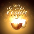 Broken golden easter egg with rays of light on a gold background. Bokeh light and glare from a cracked golden shell. Happy easter Royalty Free Stock Photo