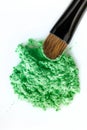 Broken green eye shadow and makeup brush isolated on white background Royalty Free Stock Photo