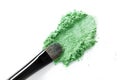 Broken green eye shadow and makeup brush isolated on white background Royalty Free Stock Photo