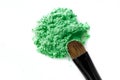 Broken green eye shadow and makeup brush isolated on white background Royalty Free Stock Photo