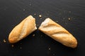 broken in half baguette on a stone background