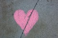 Broken heart drawn on sidewalk with chalk