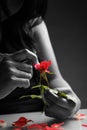 Broken heart girl picking rose petals Royalty Free Stock Photo
