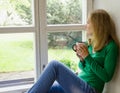 Broken heart girl sit on window sill drink coffee Royalty Free Stock Photo