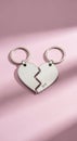 Broken Heart Keychains on Pink Fabric Royalty Free Stock Photo