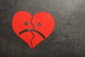 Broken heart with sad face on grey background, flat lay. Space for text Royalty Free Stock Photo