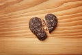 Broken heart shaped cookie on wooden background