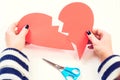 Broken heart in woman hands. Divorce concept. Unrequited love. Unhappy Valentine Day. Woman with broken heart