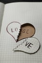 Broken heart with words LOVE and LOSE in notebook. Relationship problems concept Royalty Free Stock Photo