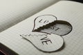 Broken heart with words LOVE and LOST in notebook. Relationship problems concept Royalty Free Stock Photo