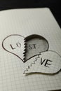 Broken heart with words LOVE and LOST in notebook on table. Relationship problems concept Royalty Free Stock Photo