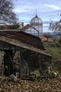 Broken historic glass house with small cupola in autumn Royalty Free Stock Photo