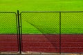 Broken iron wire fence and athletic race track Royalty Free Stock Photo