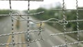 Broken iron wire fence over highway Royalty Free Stock Photo