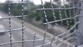 Broken iron wire fence over highway Royalty Free Stock Photo