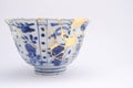 Broken Japanese handmade bowl restored with the antique japanese kintsugi real gold technique Royalty Free Stock Photo