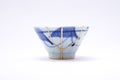 Broken Japanese handmade cup restored with the antique japanese kintsugi real gold technique Royalty Free Stock Photo