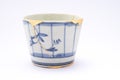 Broken Japanese handmade soba cup restored with the antique japanese kintsugi real gold technique Royalty Free Stock Photo