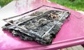Broken laptop computer spoiled by flame melted plastic. Computer damage Royalty Free Stock Photo
