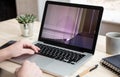 Man working with a broken laptop computer on office business background Royalty Free Stock Photo