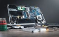 Broken laptop with a wrench and screwdriver on the table. Computer repair service Royalty Free Stock Photo