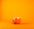 Broken large cup for tea on an orange background