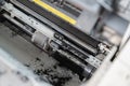 Broken laser printer cartridge on white background. Royalty Free Stock Photo