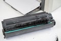 Broken laser printer cartridge on white background. Royalty Free Stock Photo