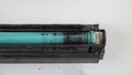 Broken laser printer cartridge on white background. Royalty Free Stock Photo