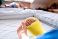 Broken leg in cast of unrecognizable little boy. Royalty Free Stock Photo