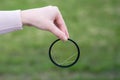 Broken lens filter in hand. Cracked photo-filter Royalty Free Stock Photo