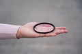 Broken lens filter in hand. Cracked photo-filter Royalty Free Stock Photo