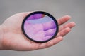 Broken lens filter in hand. Cracked photo-filter Royalty Free Stock Photo