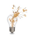 Broken light bulb with coins Royalty Free Stock Photo