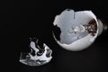 Broken light bulb isolated on black background with shattered piece of lightbulb. Royalty Free Stock Photo