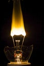 Broken lightbulb with filament bursting into flame Royalty Free Stock Photo