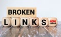 Broken links - text concept website on a wooden background surrounded by cubes