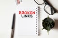 Broken links - text on yellow note sheets on a dark wooden background with crumpled sheets