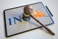 Judge's gavel and broken tablet computer screen with logo of ING. Editorial conceptual 3d rendering
