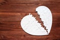 Broken Love: Heart Puzzle on Wooden Table Royalty Free Stock Photo