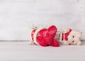 Broken love,Teddy bear and red hearts.on grunge white wood background